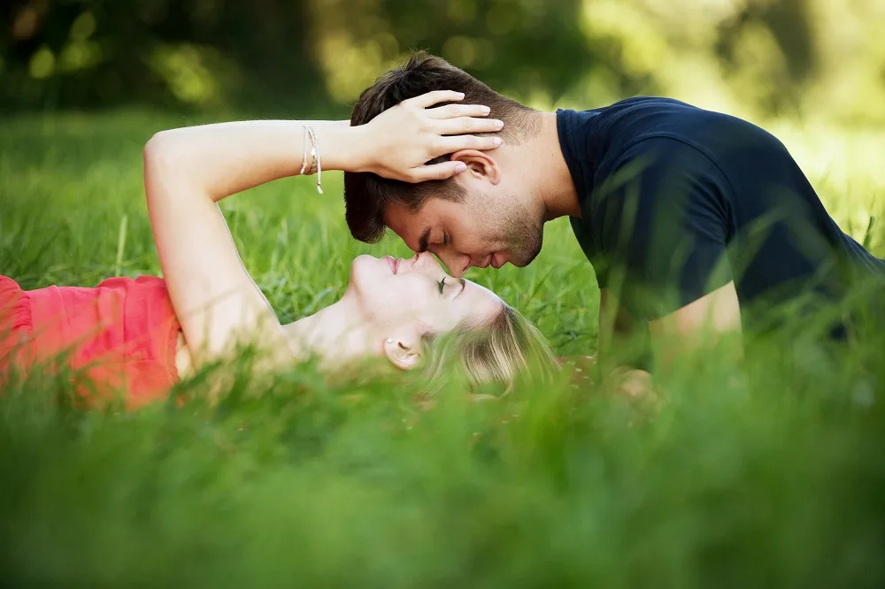 couple laying in the grass