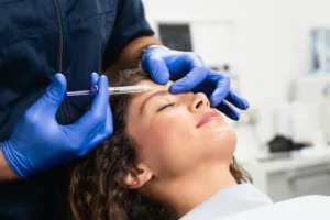 Woman getting botox in her forehead