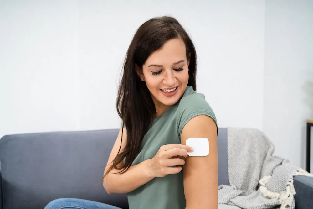 Woman using her Bio-Identical Hormone Replacement Therapy patch