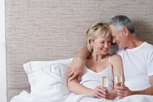 woman and man happy in bed together after a successful vaginal rejuvenation