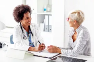 A female doctor speaking with her patient about the benefits and safeness of a procedure.