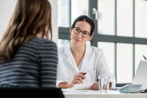 A woman speaking to her doctor about the before and after care for her procedure.