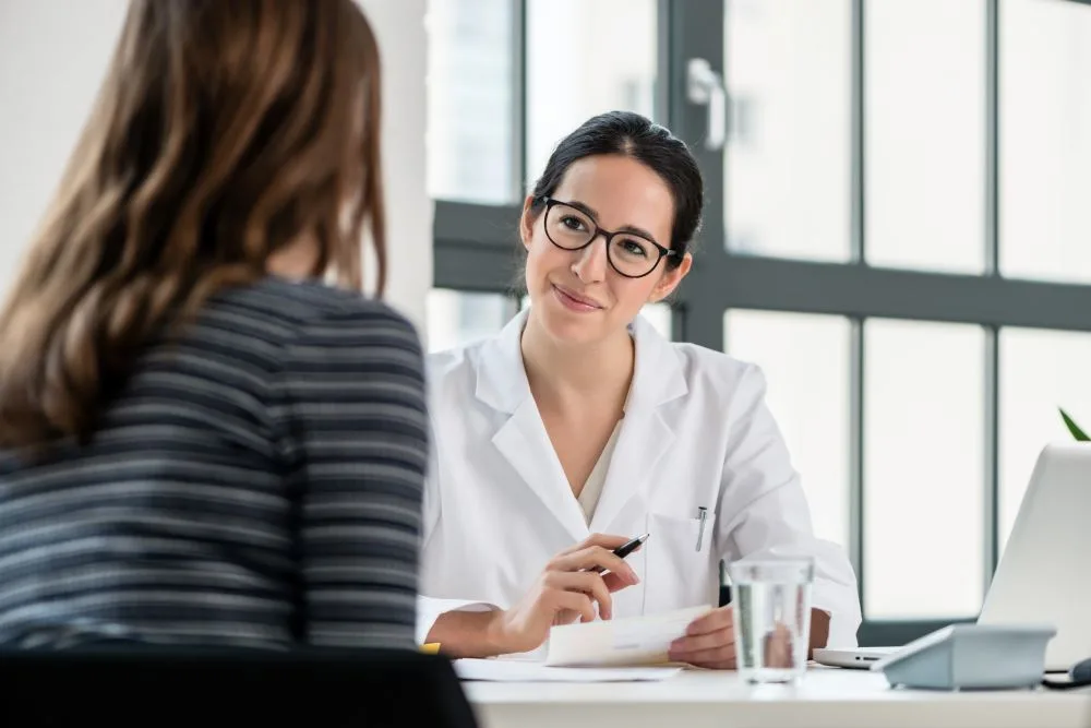 A woman speaking to her doctor about the before and after care for her procedure.