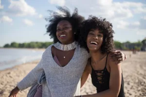 Two friends excited to hang out on the beach together.
