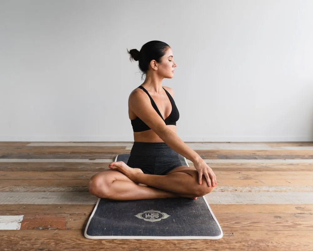 A young woman stretching before her workout.