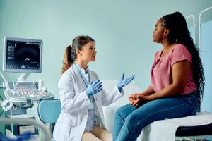A woman speaking to her gynecologist about her health concerns.