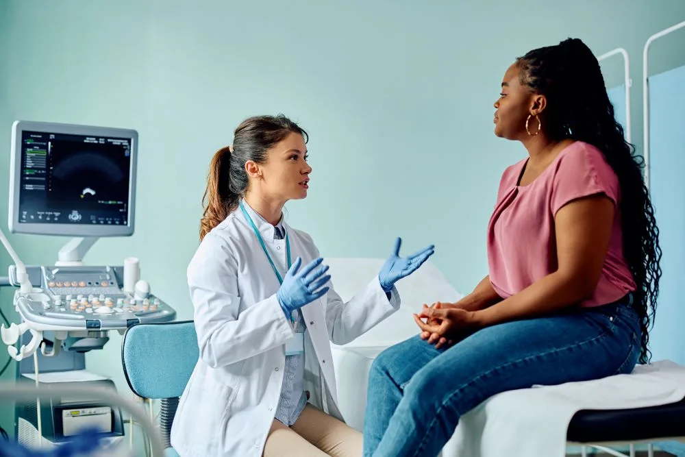 A woman speaking to her gynecologist about her health concerns.
