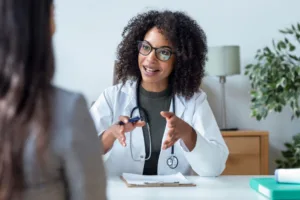 A doctor speaking to her patient about a potential treatment plan.