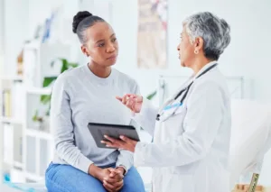 A woman speaking to her doctor about a potential procedure.