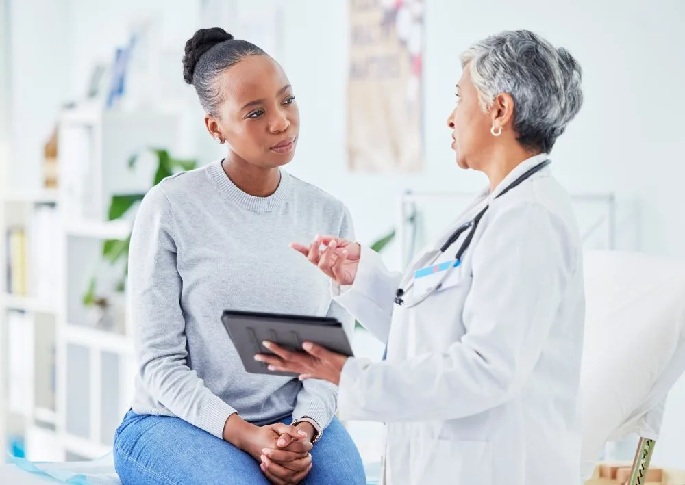 A woman speaking to her doctor about a potential procedure.