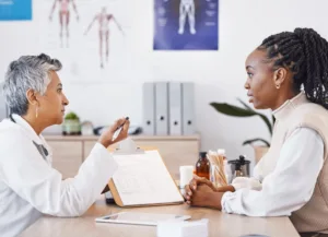 A doctor speaking to her patient about safety measures and potential side effects of a procedure.