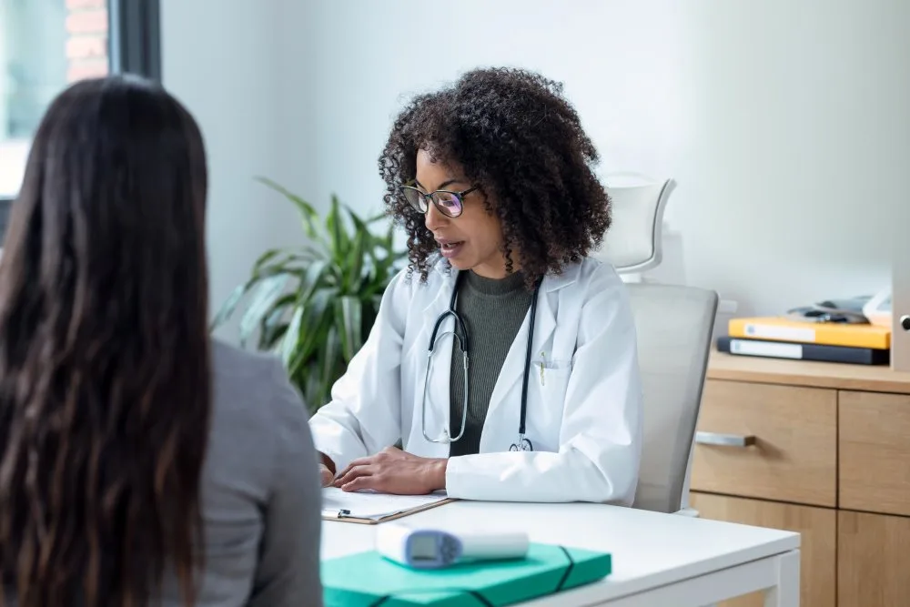 A woman speaking with her doctor about post operative care.