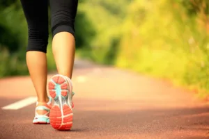 A woman walking on a hiking trail.