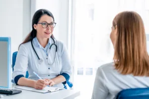 Adult doctor working and listening to the patient in modern clinic.