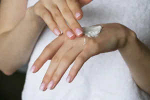 A woman using skin bleaching creams to lighten hand.