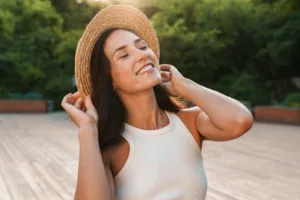 A woman smiling outside after rediscovering her confidence.